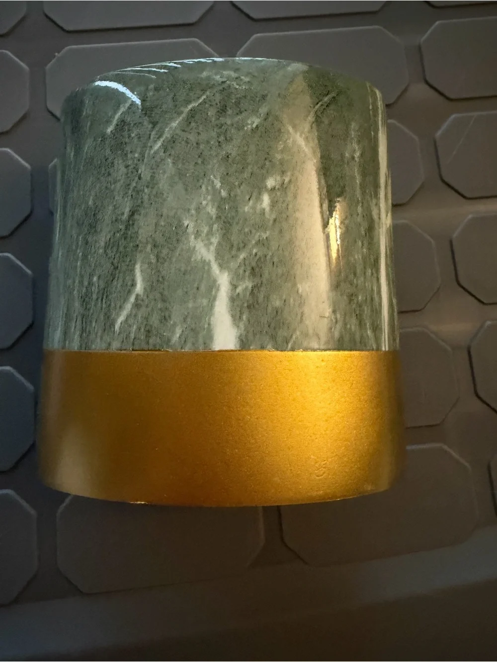 Toothbrush holder green marble pattern with gold colored base.